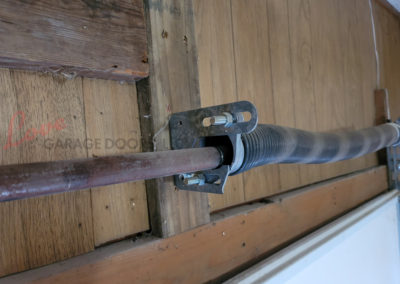 Garage Door Repair, Torsion Spring Center Bushing is missing and cutting the Torsion Bar in half.