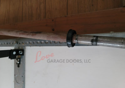 Garage Door Repair, Torsion Spring Center Bushing is missing and cutting the Torsion Bar in half.